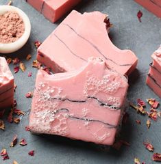 some pink soaps are sitting on a table