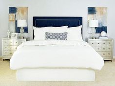 a bedroom with white bedding and blue accents