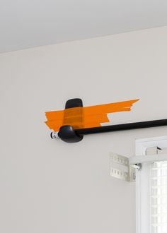 an orange and black object hanging on the wall