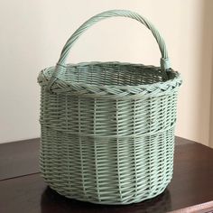 a wicker basket sitting on top of a wooden table