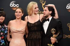 the cast of game of throne poses in the press room with their award for best tv series