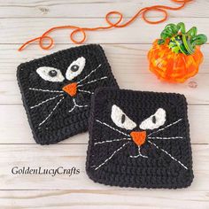 two black crocheted coasters with white eyes and orange nose, one has an orange pumpkin in the background