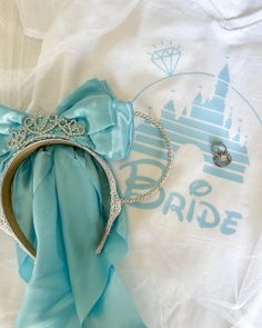 a tiara and ring laying on top of a t - shirt