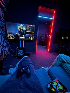 a person laying on the floor in front of a tv playing video games at night