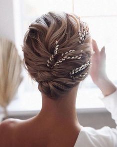 a woman with braids in her hair looking out the window