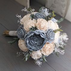 a bridal bouquet on the floor with baby's breath