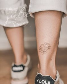 a woman's foot with a small tattoo on her left leg and the word yola written in black ink