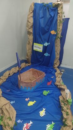 a room with blue tarp and fish on the floor