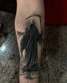 a man's leg with a tattoo on it that has an image of a person holding