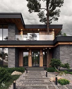 a modern house with large windows and stone steps leading up to the front door area