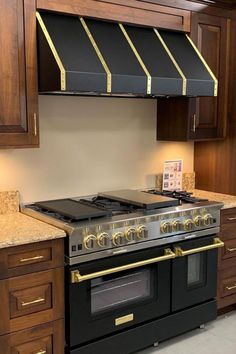 a stove top oven sitting inside of a kitchen next to wooden cupboards and counter tops