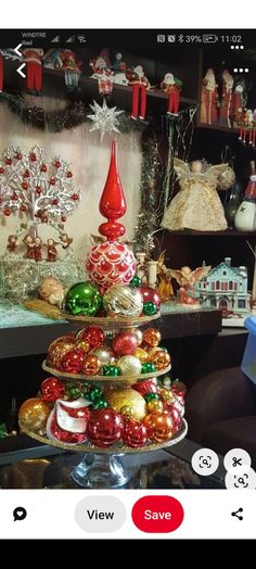 a christmas tree made out of ornaments on a table with other items in the background