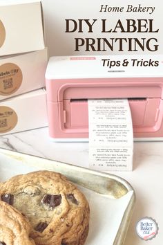 two chocolate chip cookies sitting on top of a white plate next to a pink microwave