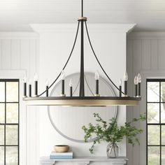 a chandelier hanging over a fireplace in a living room