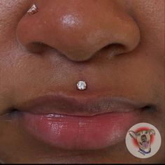 a close up of a person with a nose piercing on their nose and the bottom part of her nose