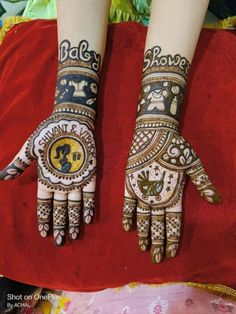 two hands with henna designs on them