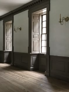 an empty room with wooden floors and two doors on either side of the door,