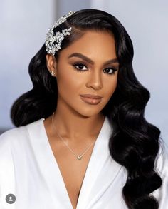 a woman with long black hair wearing a white dress and a tiara on her head