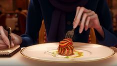 a woman sitting at a table in front of a plate with a fork sticking out of it