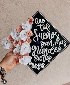 a hand holding a graduation cap with flowers on it that says, one this seven years son has graces after me