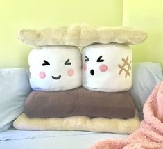 two pillows sitting on top of a couch