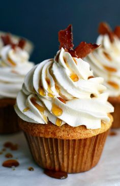 cupcakes with white frosting and bacon on top