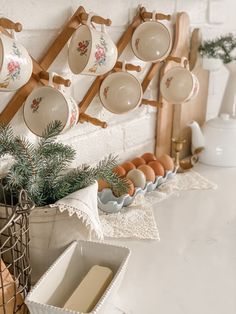 an assortment of dishes and utensils hanging on the wall