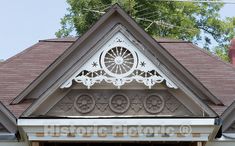 the front entrance to a house with a clock on it's roof