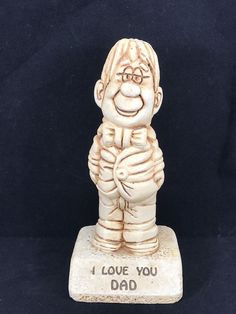 a ceramic figurine that says, i love you dad on it's base