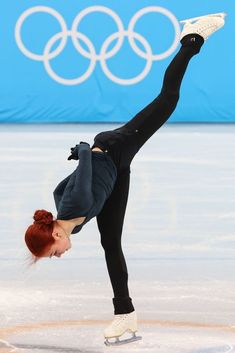 a female figure skating on an ice rink