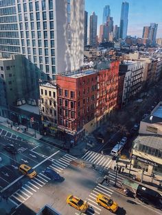 a city street filled with lots of traffic next to tall buildings