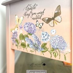 a mirror with flowers and butterflies painted on it