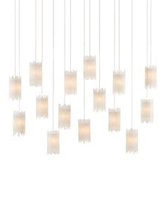 a bunch of lights that are hanging from a ceiling fixture with white shades on them