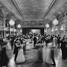 black and white photograph of people dancing in a ballroom