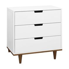 a white dresser with three drawers and two black handles