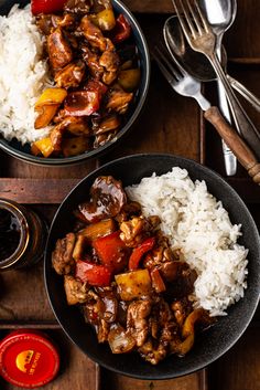 two bowls filled with rice, meat and veggies on top of a wooden table