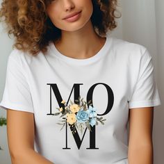 Trendy Mom TShirt: Show Mom your love with our heartfelt designs that celebrate her strength, love, and unwavering grace. Shop now and give her a gift as unique and beautiful as she is! Crafted from our BELLA AND CANVAS brand, this tee offers style and comfort. Here's what you need to know before you make your purchase: * Unisex Adult Sizing. * Rolled Sleeves in pictures are for styling purposes only. * Props used in photos are NOT included with purchase. PRINT DESIGN * This is a Direct-To-Garment printed item, ensuring durability without cracking or peeling. * The ink is printed INTO the fabric, ensuring longevity. WASHING INSTRUCTIONS * Wash inside out, in cold water, on a gentle cycle. Tumble dry low or let air dry. * Do not use Fabric Softeners or Bleach. * Do not dry clean. Avoid iron Letter Print Tops For Mother's Day, Mother's Day Gift Tops With Letter Print, Mother's Day Letter Print Tops Gift, Mother's Day Graphic Tee Tops As Gift, Mother's Day Gift T-shirt, Name Print Tops For Mother's Day, White T-shirt For Mother's Day Gift, Mother's Day Text Print Top, Mother's Day Gift Graphic Tee