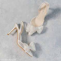 two pairs of wedding shoes with bows on the toes and heels are shown in white lace