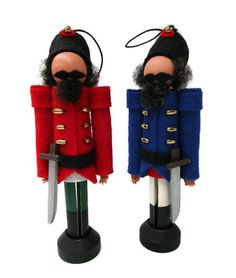 two toy soldiers are dressed in red, blue and green uniforms with swords on their heads