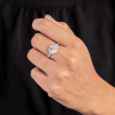 a woman's hand with a diamond ring on her finger