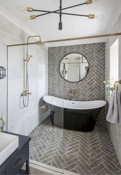 a bathroom with a black and white bathtub next to a mirror on the wall