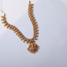 Description A cascading long necklace set fit for bridal parties is a definition of regalia and opulence. Studded with semi-precious Kempu stones. A head-turner, this antique gold-plated necklace features a central Goddess Lakshmi motif surrounded by floral, peacock, and elephant nuances. Dangling pearl clusters add a royal charm to this choker. Product Information Materials used: 925 Silver with 1.0-microns Antique Gold Plating Stones: Semi precious stones Length: N-30.5, E-6.5 cm Findings: Hoo Luxury Hand Set Temple Necklace For Celebrations, Luxury Temple Jewelry Sets For Festive Season, Luxury Traditional Temple Necklace For Ceremonial Occasions, Luxury Multicolor Temple Jewelry Danglers, Luxury Bohemian Temple Necklace For Ceremonial Use, Luxury Traditional Temple Necklace With Cutdana, Luxury Fusion Style Temple Necklace With Intricate Design, Luxury Traditional Sterling Silver Temple Necklace, Luxury Traditional Temple Necklace With Filigree