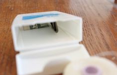 a piece of white tape sitting on top of a wooden table