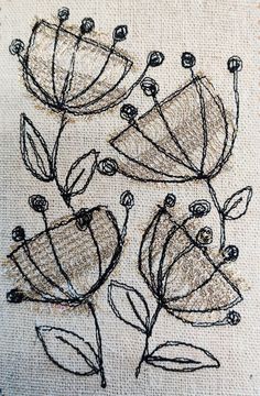 a close up of a piece of cloth with embroidery on it and flowers in the middle