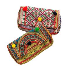 Venya Clutch Vintage banjara clutch is a one of a kind bag crafted from Indian fabric, and embellished with mirror, embroidery, metallic thread or pom-poms. Each one a true work of art. Your bag will be similar to those shown here, but remember, each one is 100% unique and will surprise you with its chic charm. Lined. Magnetic closure. Dimensions: Length 11″ – Width 2.25″ – Height 6.75″ Mirror Embroidery, Indian Fabric, Small Mirrors, Vintage Indian, Upcycled Vintage, Metallic Thread, Gucci Dionysus, Pom Poms, Clutch Purse