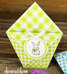 an origami box with a bunny on it next to some other paper crafts