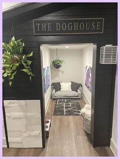 the doghouse is decorated in black, white and grey colors with an indoor plant