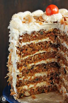 a large slice of carrot cake on a blue plate