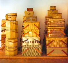 several stacks of wicker baskets stacked on top of each other in front of a wall