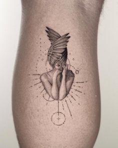 a woman's thigh with a tattoo design on the side of her leg and an arrow